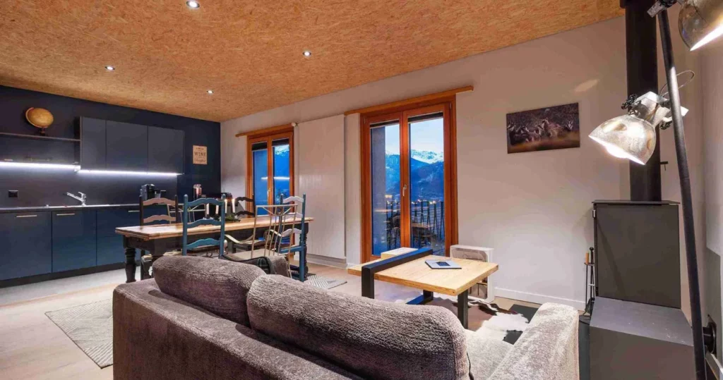 Modern kitchen and lounge area with mountain views in Apartment L Atelier near Crans-Montana